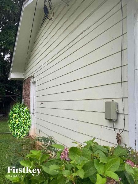 the side of a white house with a sensor on the side