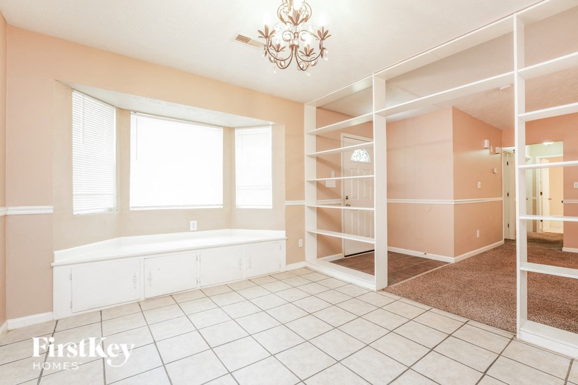 a large bathroom with a tub and a closet