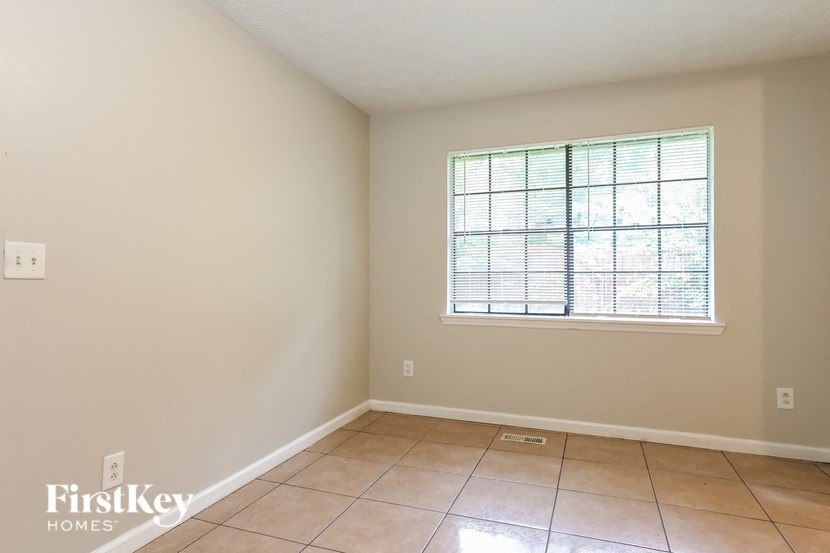 a empty room with a window and a tiled floor
