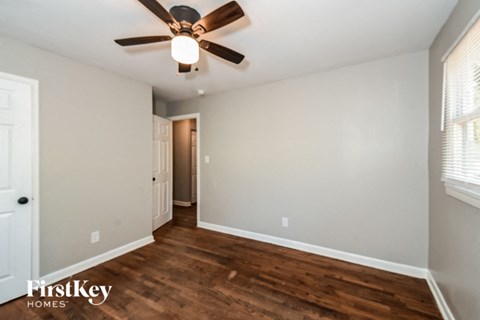 a living room with a ceiling fan and wood flooring
