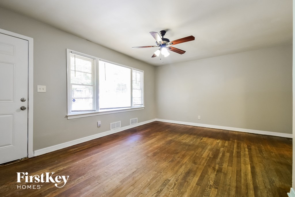 a living room with wood floors and a ceiling fan