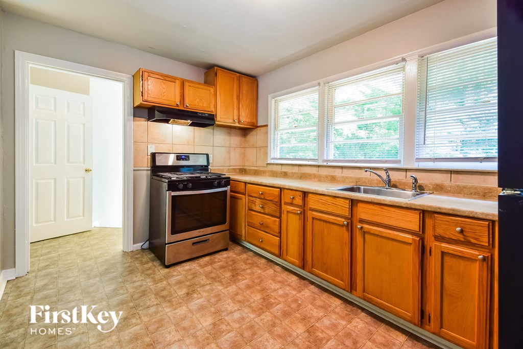a kitchen with wooden cabinets and stainless steel appliances