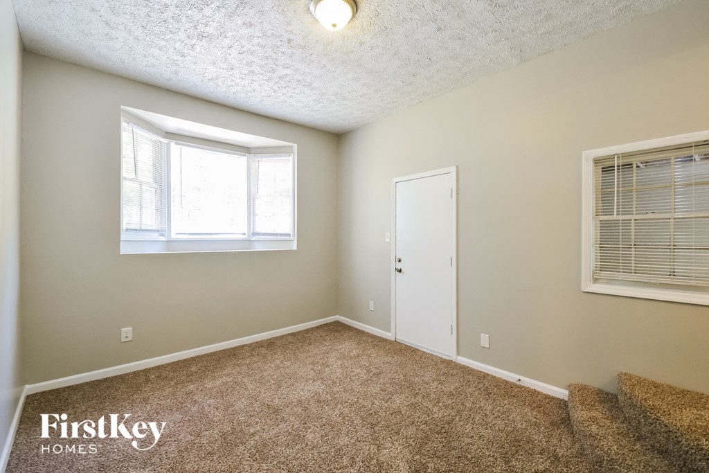 a living room with carpet and a window