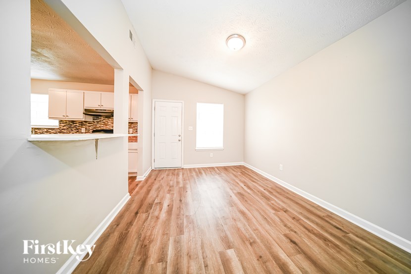 A room with wooden floors and a white door.