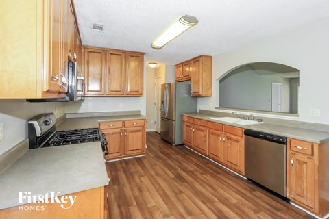 a kitchen with wooden cabinets and stainless steel appliances
