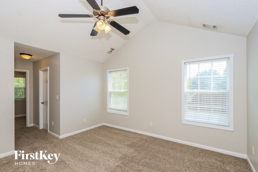 the living room of a home with a ceiling fan