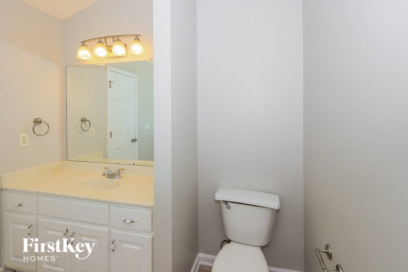 a bathroom with a toilet and a sink and a mirror