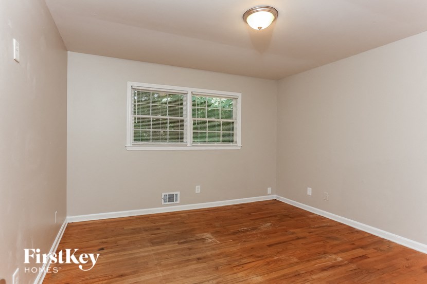 a empty room with a hardwood floor and a window