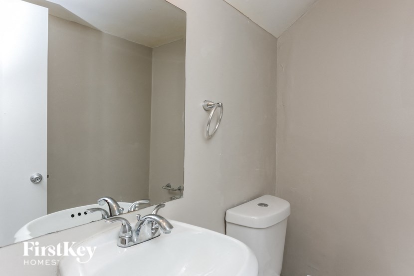 a bathroom with a sink and a toilet and a mirror