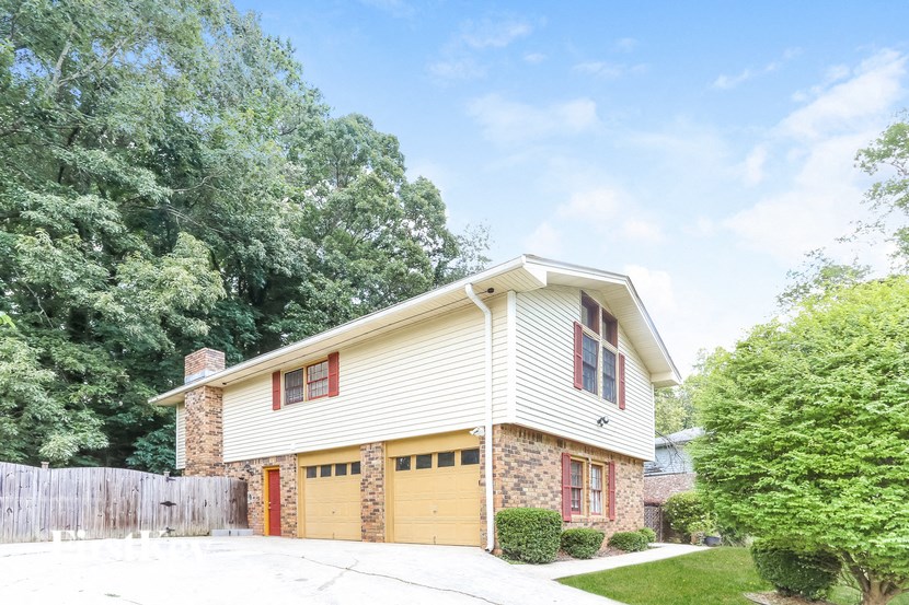 a white house with a yellow garage door