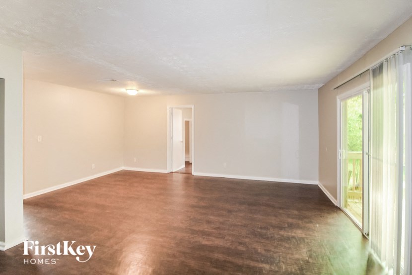 A room with a brown floor and white walls.
