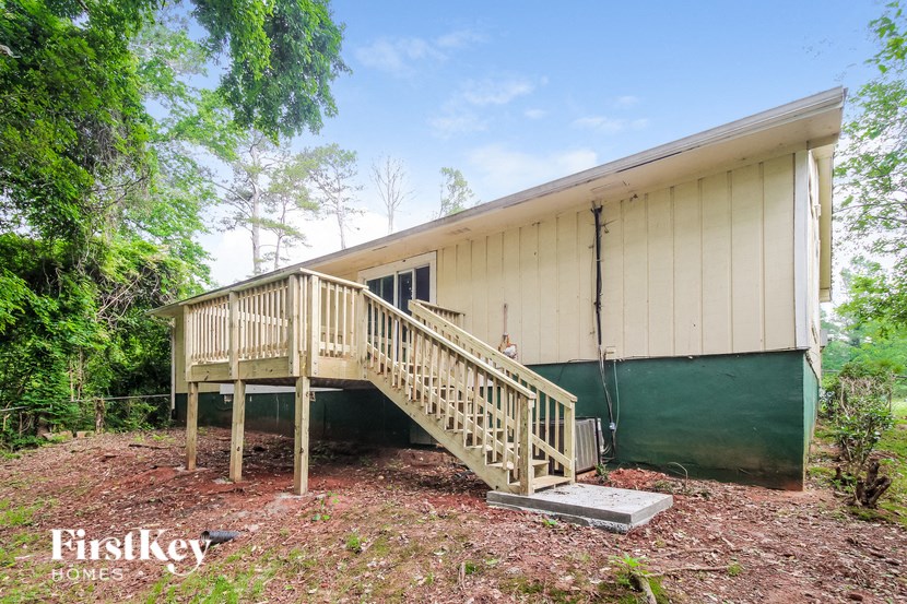 A wooden staircase leads to a building with a FirstKey Homes sign.