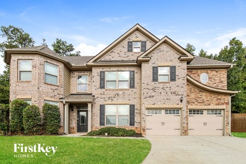 a brick house with two garage doors