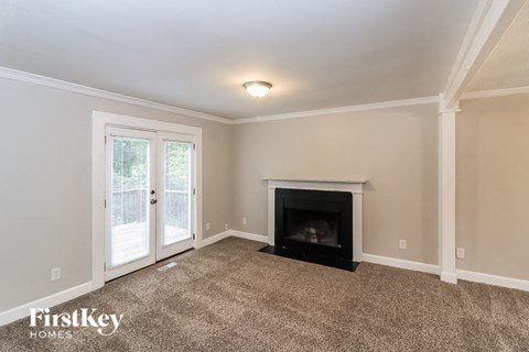 a living room with a fireplace and a door to a patio