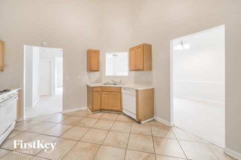 a clean kitchen with a sink and a refrigerator