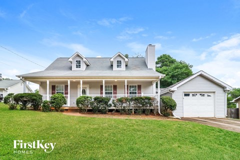 a white house with a lawn and a white garage door