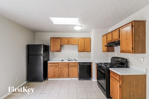 a kitchen with black appliances and wooden cabinets