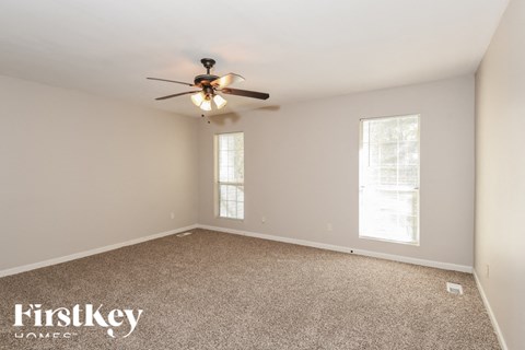 a bedroom with carpet and a ceiling fan
