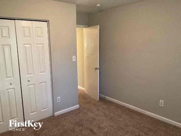 a empty room with a door and a closet