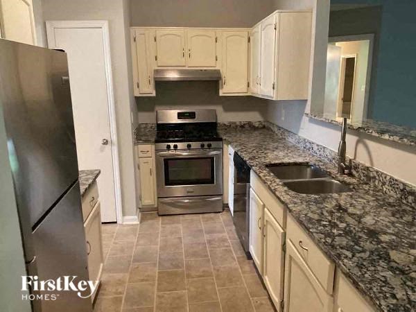 a kitchen with granite counter tops and stainless steel appliances