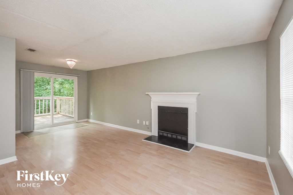 a living room with a fireplace and a wooden floor