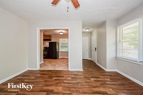 a living room with a hard wood floor and a large window