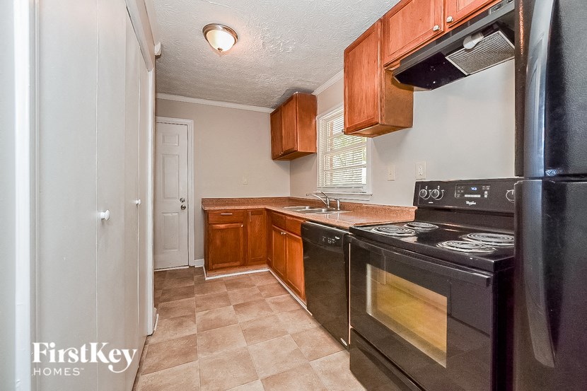 a kitchen with black appliances and wooden cabinets