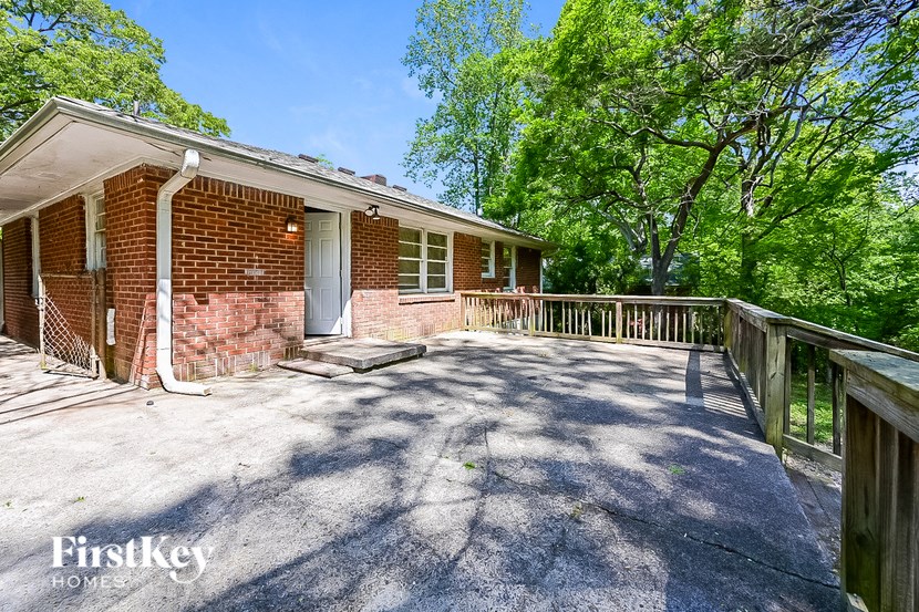 a brick house with a porch and a deck
