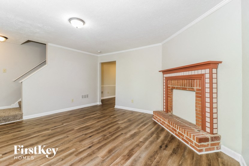 a living room with a fireplace and a wooden floor