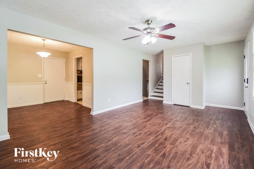 A room with wooden floors and a ceiling fan.