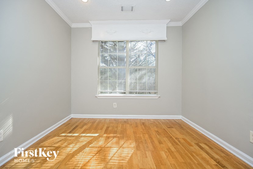 a living room with wood floors and a window