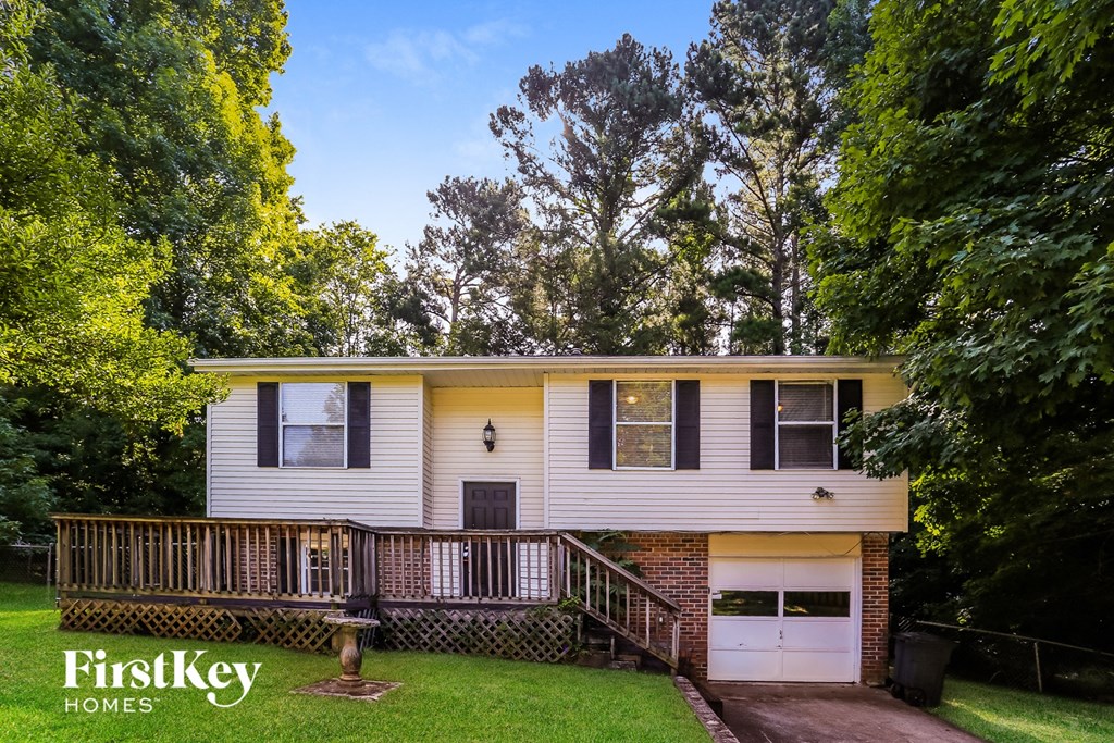 a yellow and with a deck and a porch