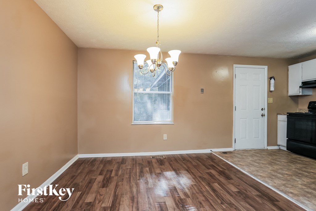 the living room and dining room of an empty house