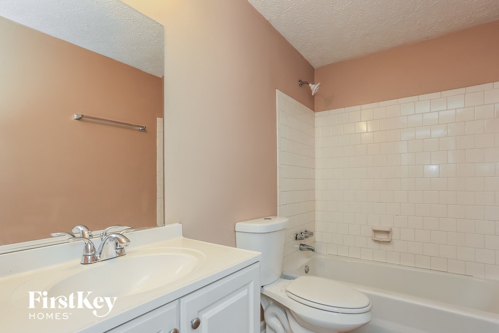 a bathroom with a sink toilet and a tub