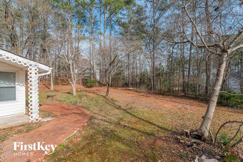 a house on a dirt road in the woods
