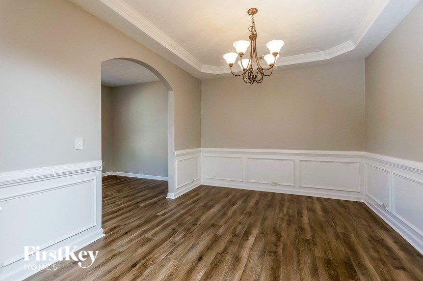 A room with wooden floors and a chandelier.