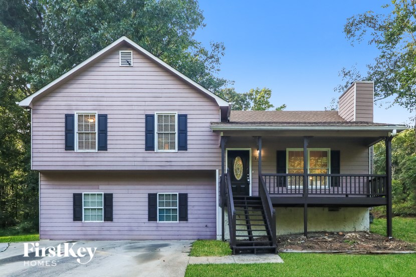 A house with a porch and a staircase leading to the front door.