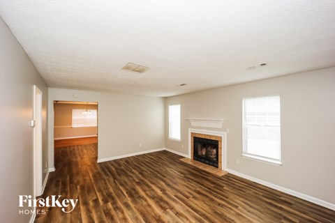 A room with a fireplace and a window.