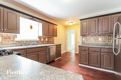 a kitchen with wooden cabinets and granite counter tops