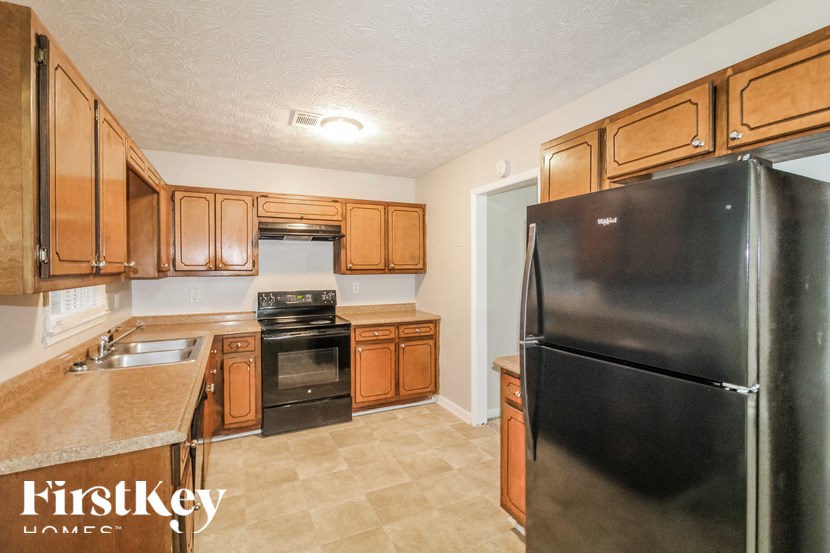 a kitchen with black appliances and wooden cabinets