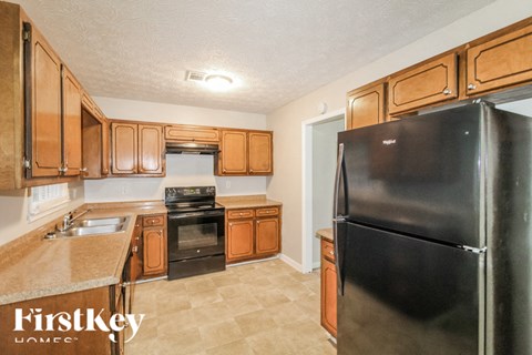 a kitchen with black appliances and wooden cabinets