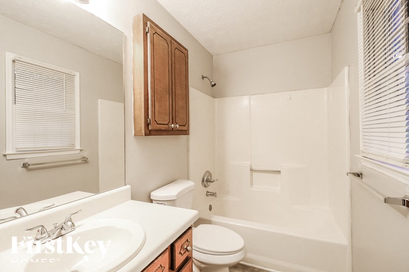 a bathroom with a sink toilet and a bath tub