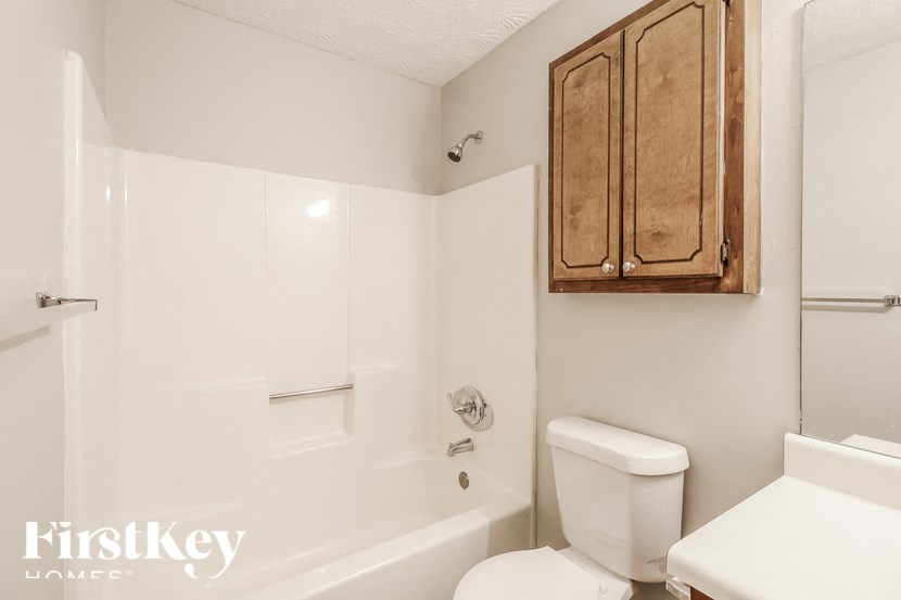 a bathroom with a toilet and a bath tub and a sink