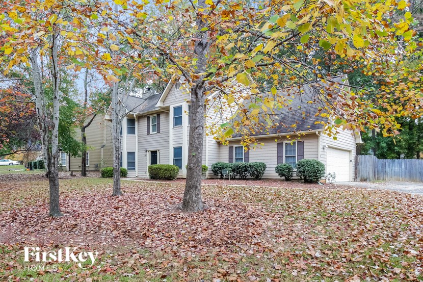 a house in the fall with leaves on the ground