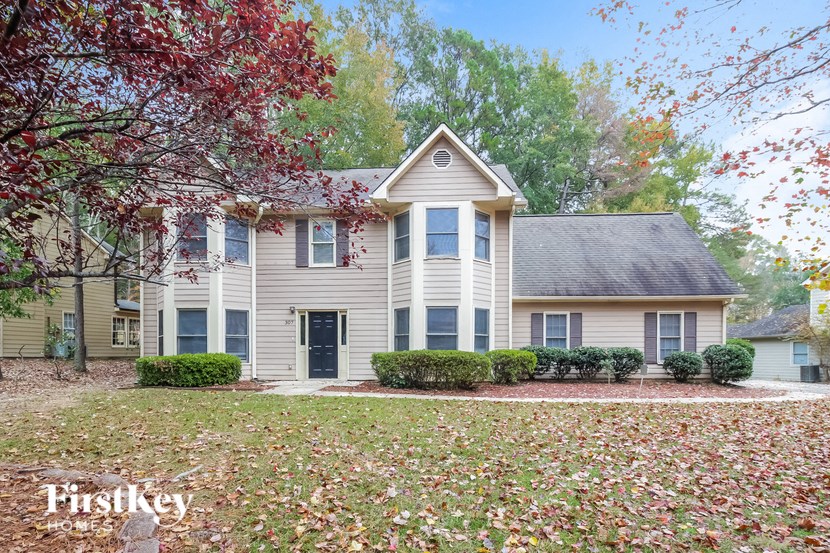 a white house with a yard in front of it