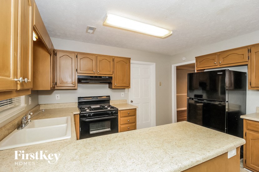 a kitchen with wooden cabinets and black appliances