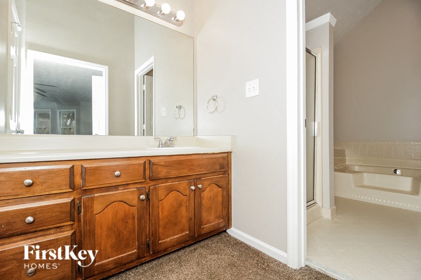 a bathroom with a large mirror and a sink