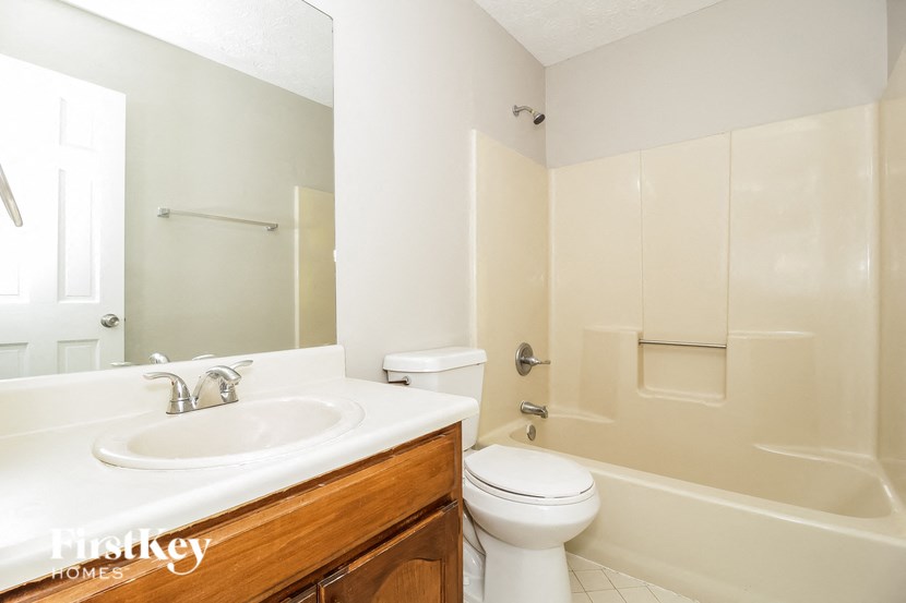 a bathroom with a sink toilet and a bath tub