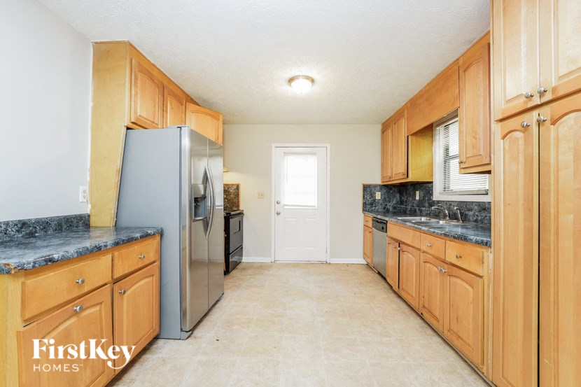 a large kitchen with wooden cabinets and stainless steel appliances