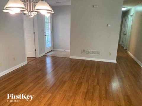 an empty living room with a hard wood floor